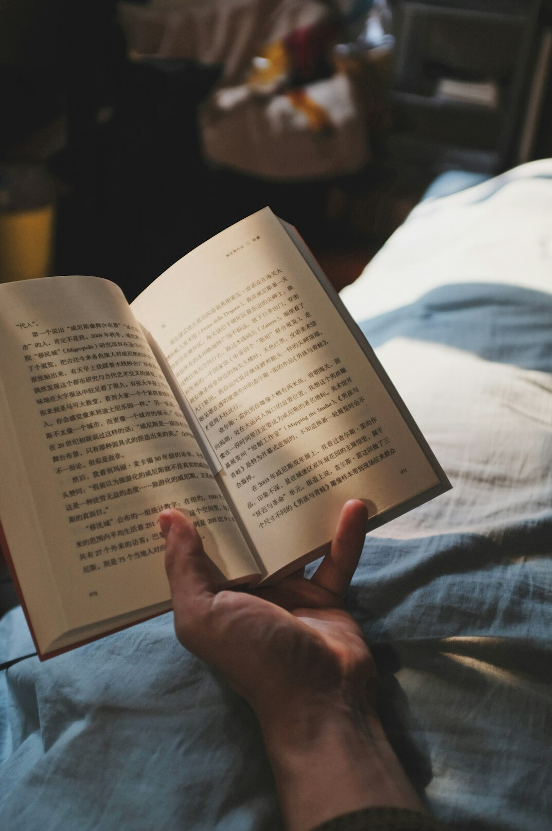 person reading in bed at night